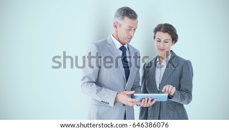 Digital composite of Business people using digital tablet over gray background