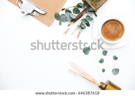Blogger or freelancer workspace with clipboard and coffee on white background. Flat lay, top view.