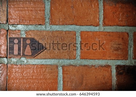 Toilet or restroom sign on the bricks wall