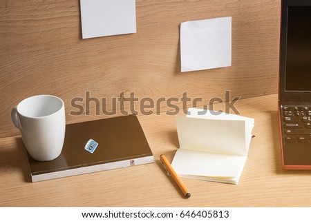 Notebook with drawings and cup of coffee on wooden table. Creative concept.