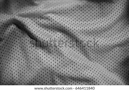 Grey sport clothing fabric texture background. Top view of grey cloth textile surface. Dark basketball shirt.