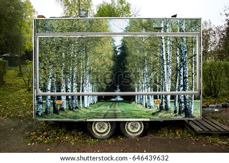 a trailer with a mural depicting the forest