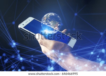 hand hold the floating globe and phone Elements of this image furnished by NASA