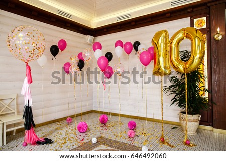 balls and balloons in room decorated for birthday party.