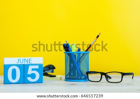 June 5th. Day 5 of month, calendar on yellow background with office suplies. Summer time at work. International Cleanup Day