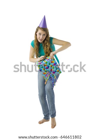 Cute young caucasian blonde girl opening her birthday gift; isolated on white background 
