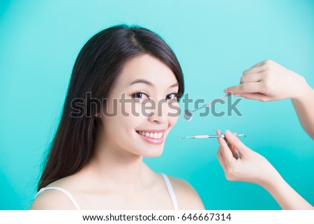 beauty woman with tooth tools on the green background