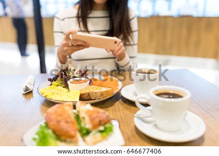 Woman taking photo on her meal