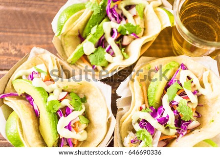 Street fish tacos with cod in recycled paper food tray.