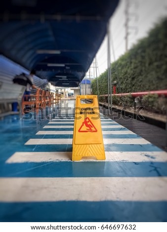 Caution wet floor or cleaning in progress. A yellow sign warning area is being cleaned.