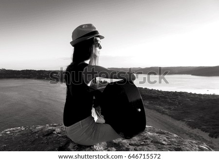 Black and white photo of a Guitarist girl at sunset, Palm Beach Australia