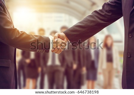 Success and Happiness Team Concept, Business man handshake at city background.

