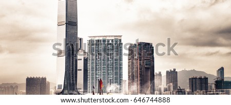 Hong Kong. Spectacular skyline with red sails boat approaching the city.