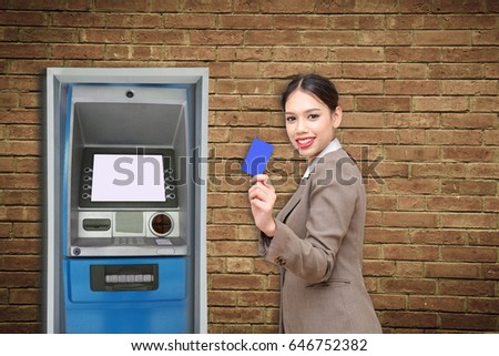 ATM machine on brick wall vintage. Business Women hold credit card to withdraw money from Automated Teller Machine to spend a purchase shopping