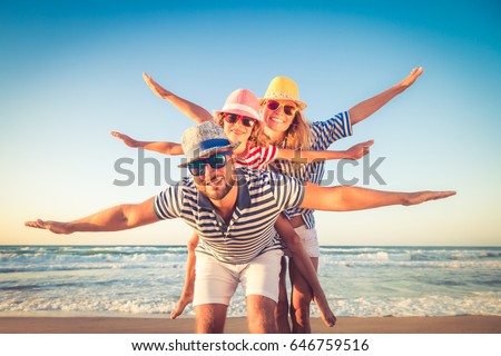 Happy family on the beach. People having fun on summer vacation. Father, mother and child against blue sea and sky background. Holiday travel concept Royalty-Free Stock Photo #646759516