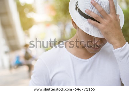 portrait of anonymous man, green city background 