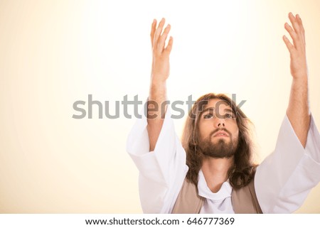 Jesus Christ raising his hands up to heaven