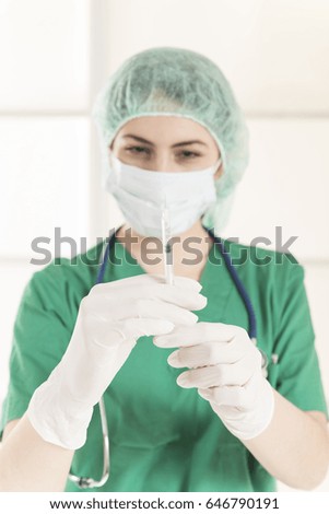 Medical doctor with syringe. Young female nurse with syringe