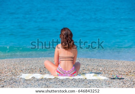 Beautiful girl on beach looking at sea side