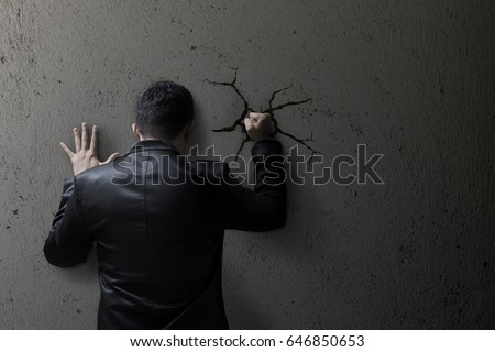 Sad business man feeling bad, hopeless, depressed, frustrated and repressed, Man hit the wall. Wall crack. Royalty-Free Stock Photo #646850653
