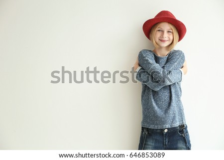 Cheerful teenager girl with red hat on white background