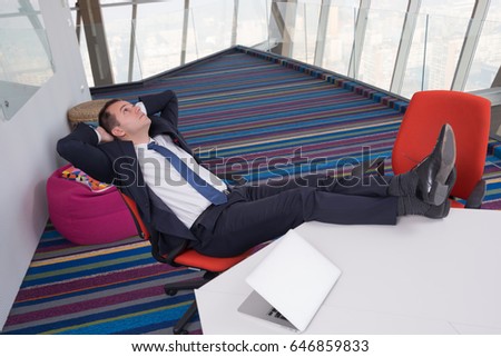 Young businessman sleeping on desk in the office