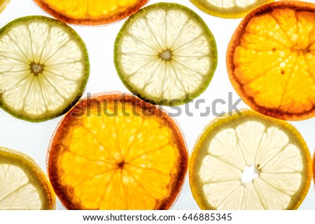 Bright mandarin, lemon and lime slices. Juicy transparent fruit on white