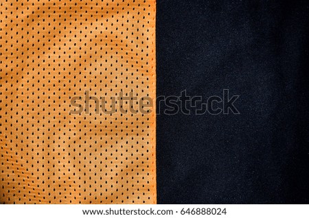 Close up of orange polyester nylon sportswear shorts to created a textured background