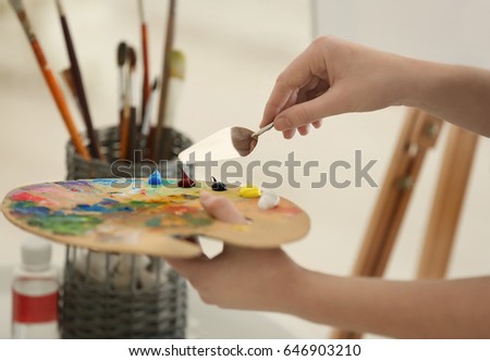 Female artist working with palette, closeup