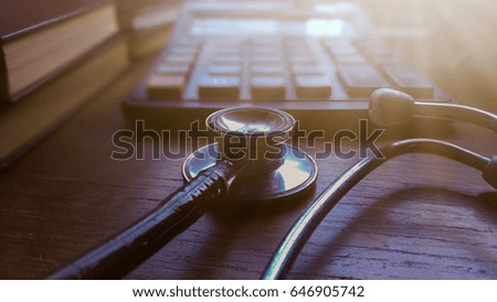 Finance and health ,Calculator and stethoscope on Wooden floor,Photos from mobile