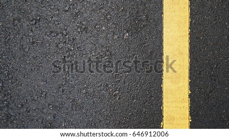 Surface rough and wet of asphalt after the rain, Grey with yellow line on the road and small rock, Texture Background, Top view