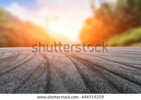 Asphalt road and fuzzy mountain background
