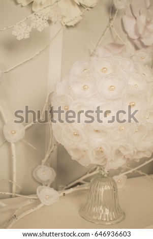 handmade bouquet of veils and beads in white on a white concrete background. Wedding card. White wedding background.