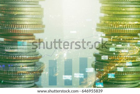 Double exposure rows of coins with night city background and column diagram,finance and banking concept