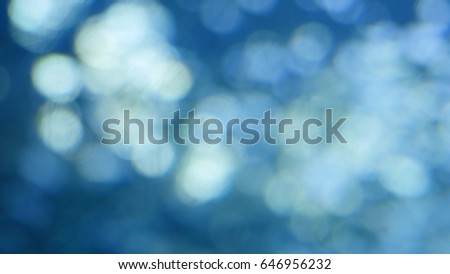 Abstract blue background with beautiful flickering particles. Underwater bubbles in flow with bokeh