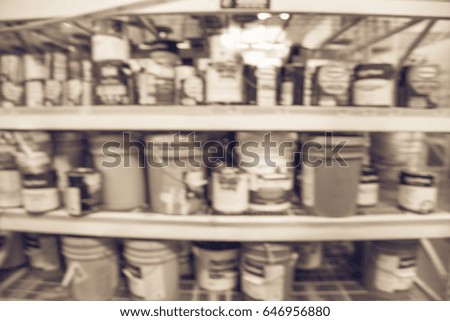 Blurred paint supplies and painting tools at paint & home decor department at store in America. Defocused racks, rows with verity of wall, floor, interior and exterior paint can products. Vintage tone
