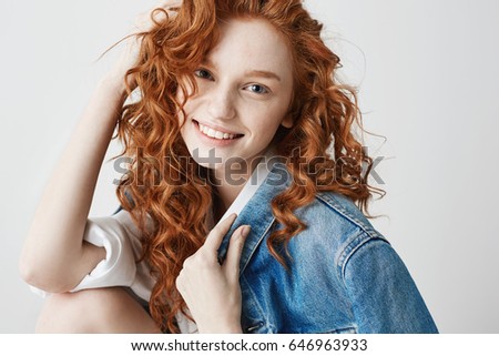 Happy cheerful foxy girl smiling looking at camera posing over white background.