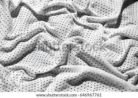 White sport clothing fabric texture background. Top view of white cloth textile surface. Bright basketball shirt. Text Space