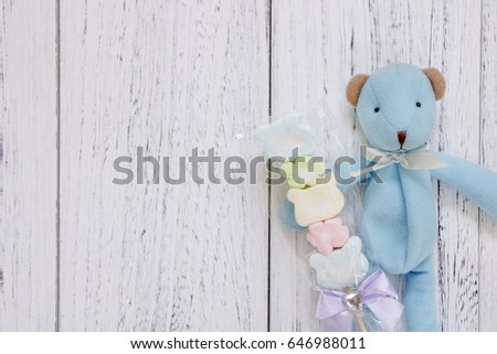 Stock Photography flat lay vintage white painted wood table blue bear doll holding cotton candy