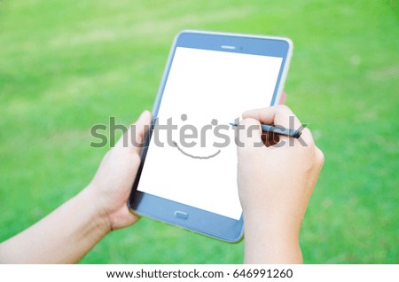 Mobile phone with smiley draw Green background