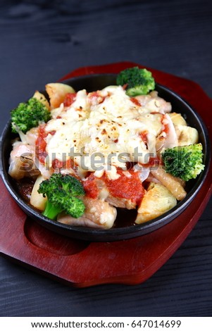 studio shot of Cheese Grilled Potatoes with Chicken on dark background