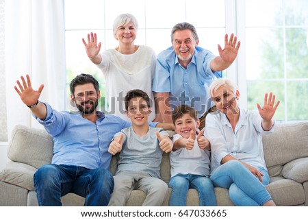 Happy family waving hands
