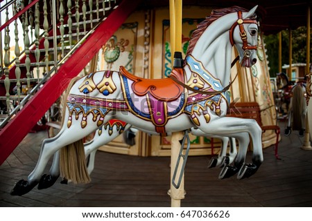 Retro carousel white / black horse. Old wooden horse carousel. Carousel! Horses on vintage, retro carnival cheerful walk. CloseUp of colorful carousel (roundabout) with horses.
