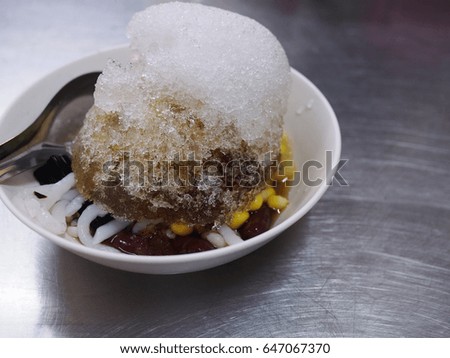 street food Chinese dessert with shaved ice topping, sweet syrup and mixed cereal 