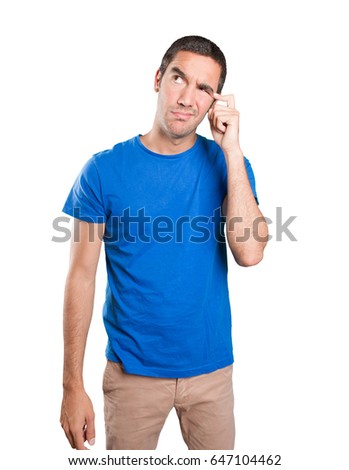 Confused young man against white background