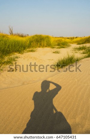 shadow of photographer on sand desert