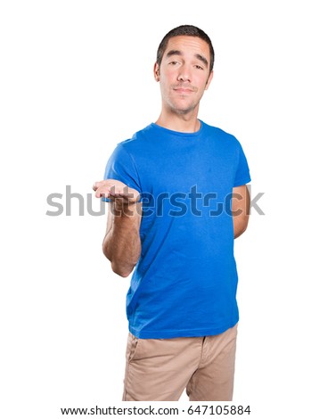 Surprised young man show gesture against white background