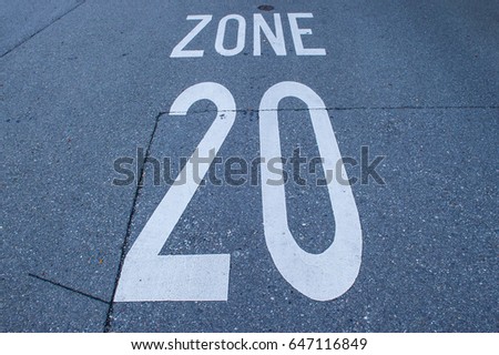 speed limit sign on a tarmac road