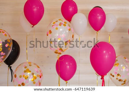 balls and balloons in room decorated for birthday party.