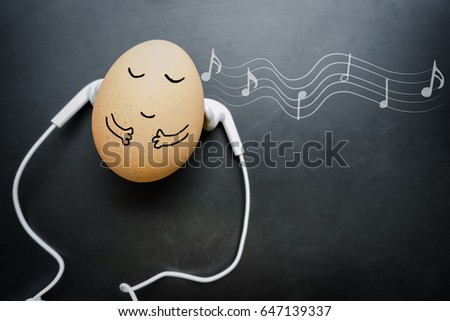 concept relaxed style in the morning with egg sleep and earphone on the blackboard and note. musical mood induction background. music style